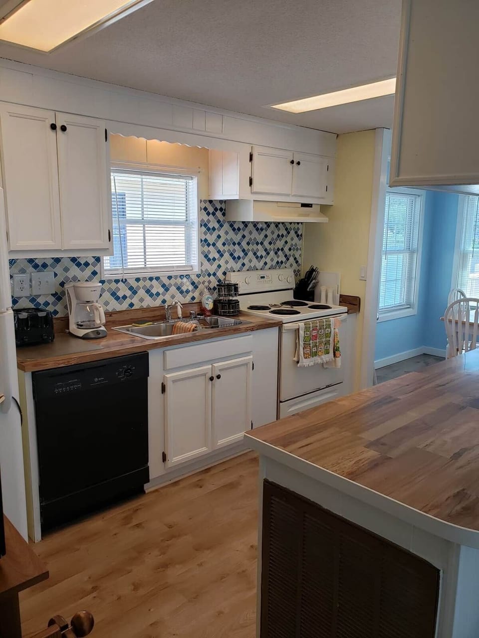 Kitchen with full stove/oven, full size refrigerator, dishwasher, garbage disposal, microwave. House includes all dishes, pots and pans, silverware, spices, storage containers.,mixer, crock pot, blender, pancake griddle, etc.