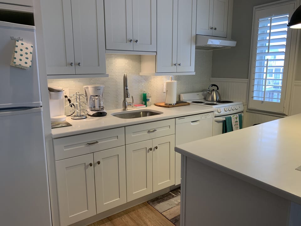 Kitchen w/ flatware, cookware, dishes (adults) & plasticware (kids & deck).