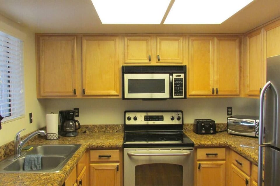 Kitchen w/ stainless steel appliances and granite counters 