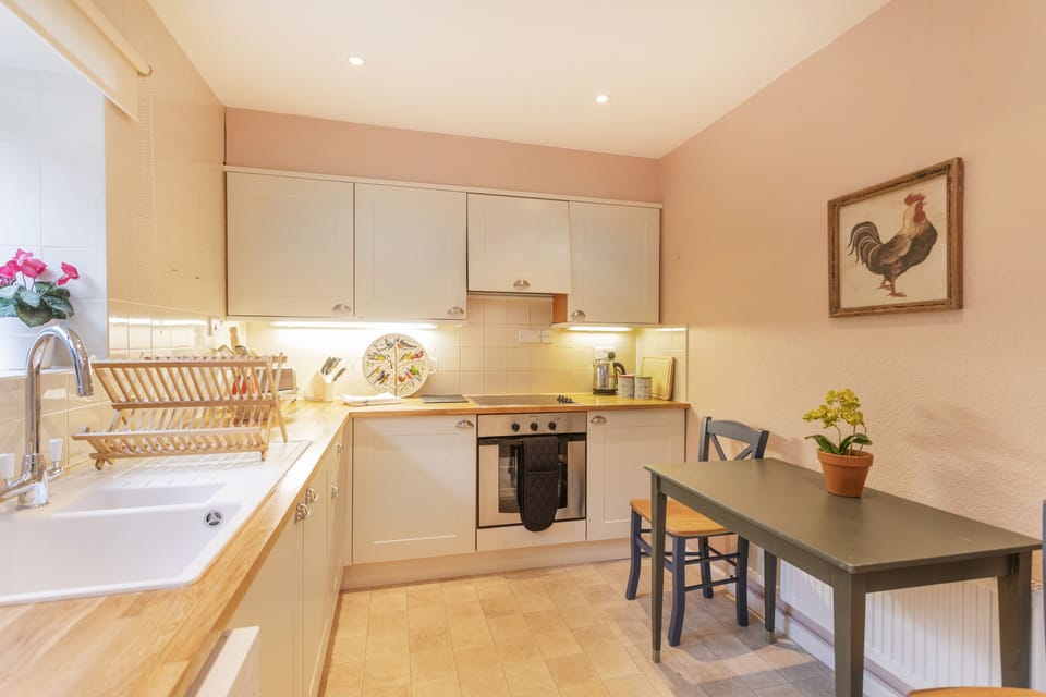 Well-equipped kitchen with dishwasher and separate pantry with freezer