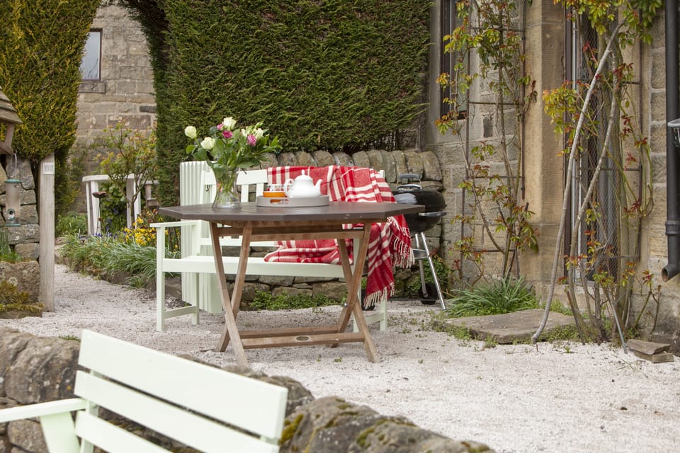 Outdoor seating area with Weber charcoal bbq and stunning views