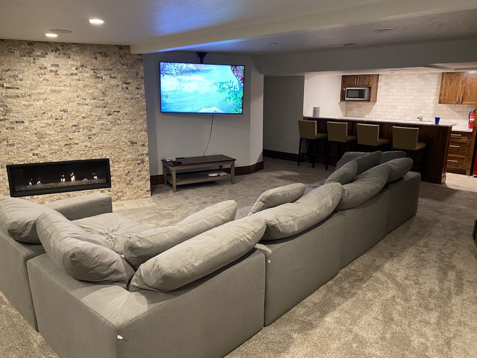 Comfy and spacious family room with kitchenette, ping pong table, & fireplace.