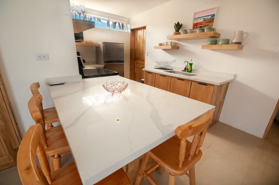 Custom, local wood kitchen cabinets with quartz’s peninsula seating 