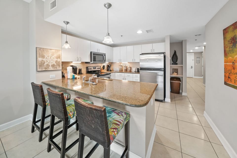 Your fully equipped kitchen features granite countertops, stainless appliances, and a breakfast bar where you can start each morning with coffee and conversation.