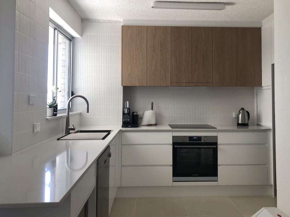 Contemporary new kitchen with stone benchtops is equipped with all you need