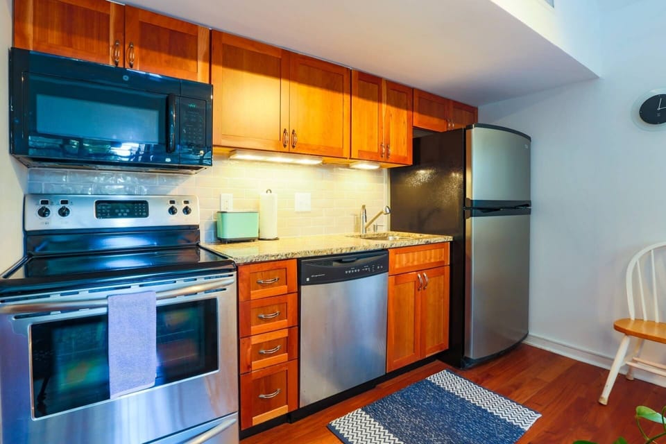 The kitchen features stainless steel appliances and granite countertops.