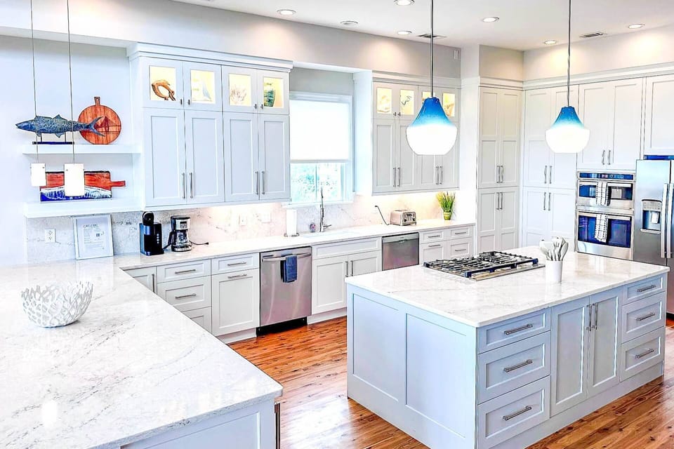 The kitchen also features a refrigerator, oven and central island with gas cook top.