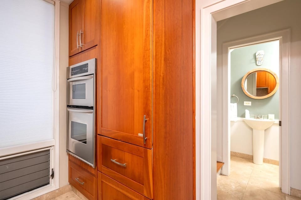   Warm wood cabinetry and neutral granite counters create a welcoming kitchen perfect for cooking and conversation    