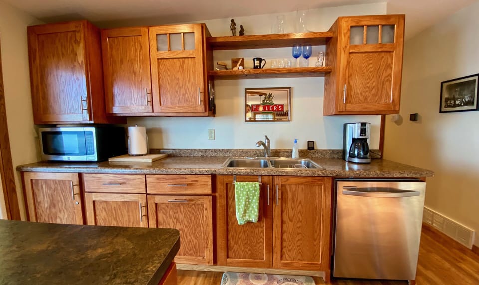 Well equipped kitchen w/stainless dishwasher, microwave, range, and refrigerator