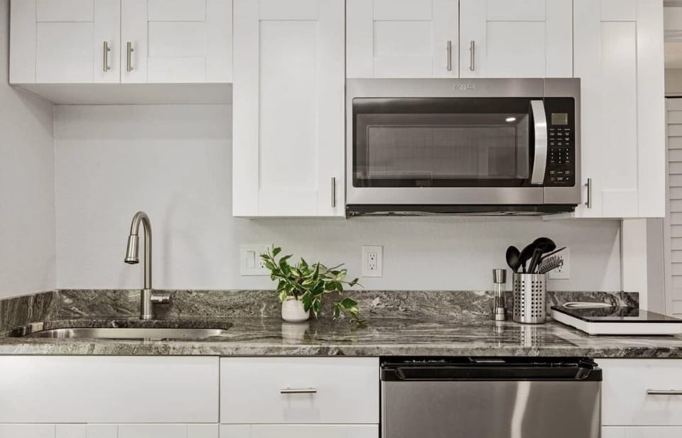 kitchen with K cup coffeemaker, convection microwave and stove top burner