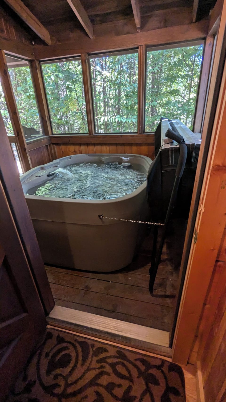 Step out of main floor bedroom into screened in area with relaxing Hot Tub!