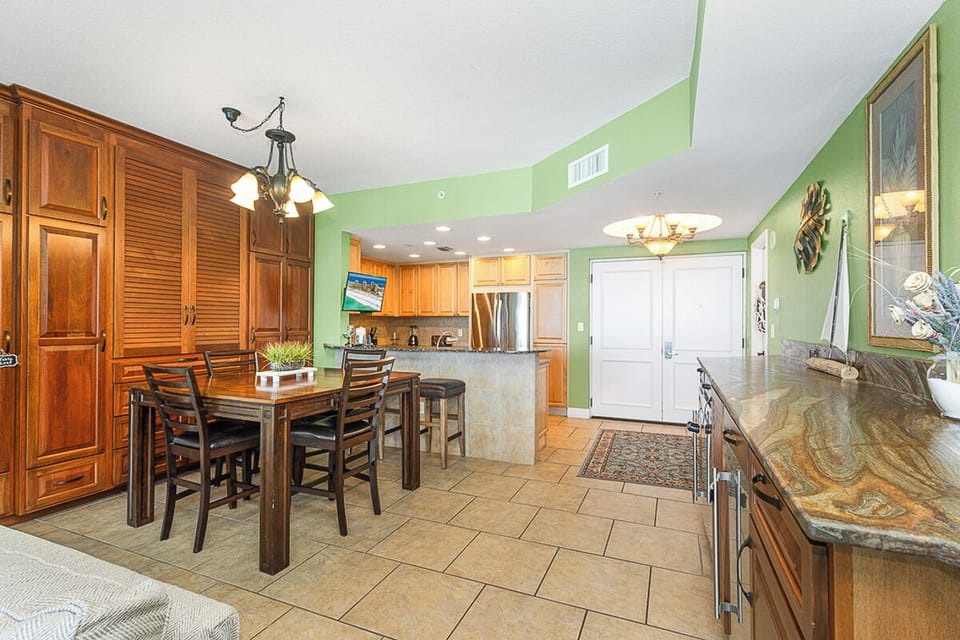 Your spacious kitchen flows seamlessly into dining, perfect for cooking and gathering with rich wood cabinets and granite countertops.