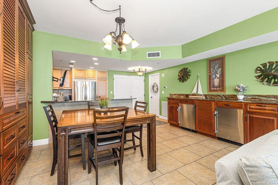 Prepare delicious meals in your fully equipped kitchen featuring granite counters, stainless steel appliances, and tropical-inspired décor.