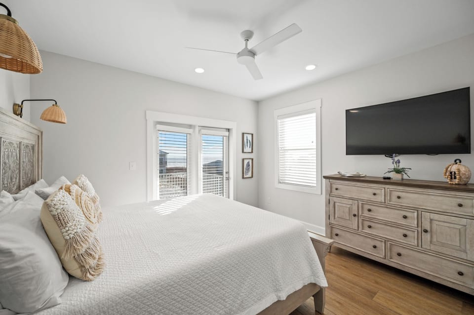 Bedroom 4 has a TV, balcony access and a private bathroom