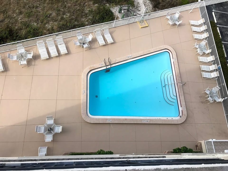 Condo pool that is steps from the beach