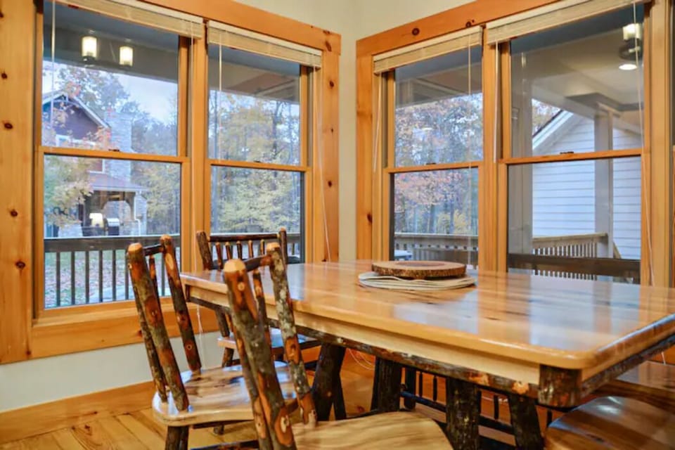 Spacious dining room table for six & four chairs and a bench and five barstools.