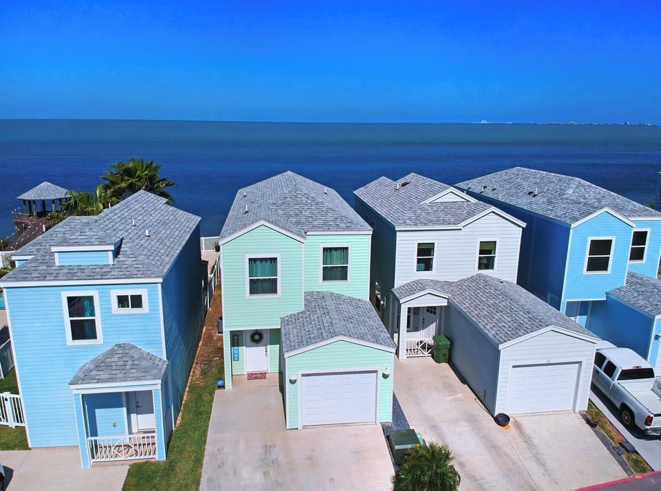 Aerial view of the green bay house with the Laguna Madre Bay as your backyard