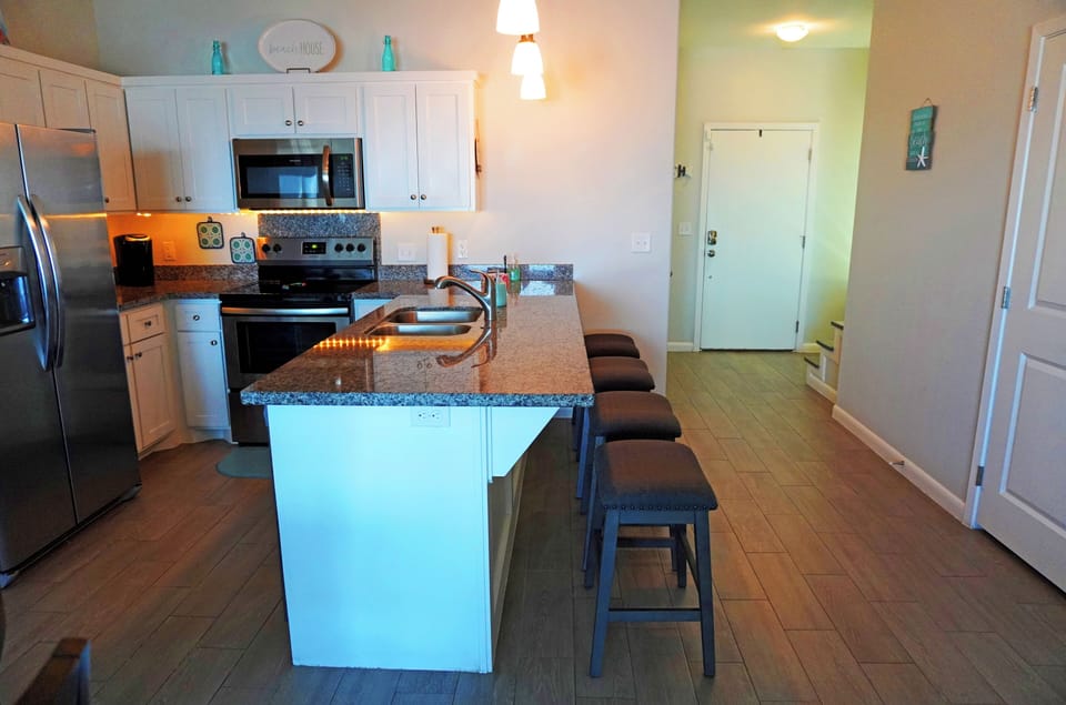 Kitchen with full appliances and 4 person bar/breakfast counter