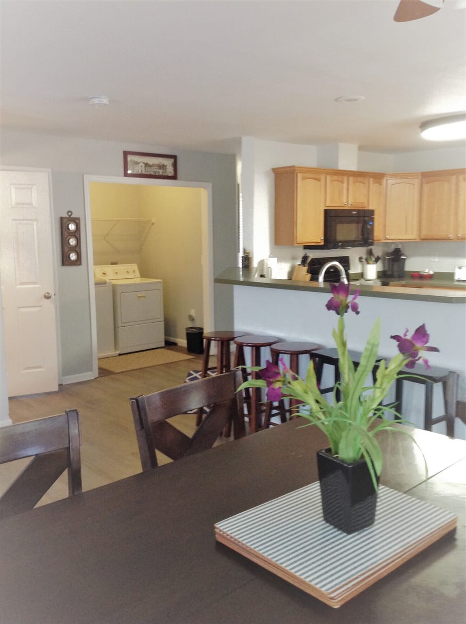 One of 2 dining tables looking towards the kitchen and laundry area