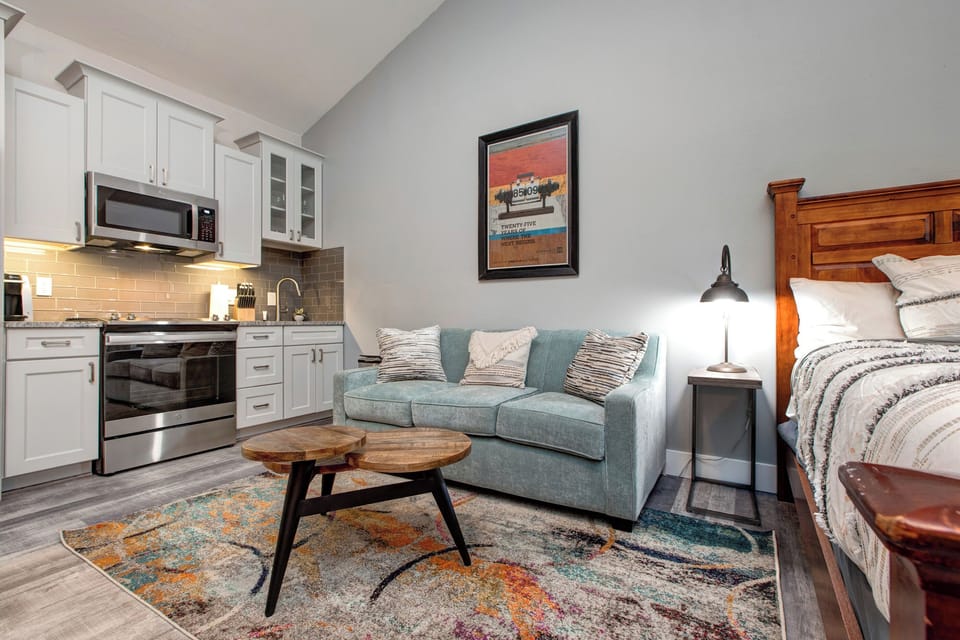 Cozy sofa bed and kitchen with a stylish center table.