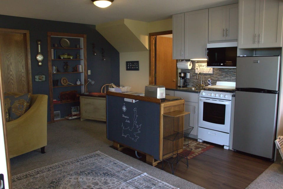 Fully equipped kitchenette with dining island and open living area.
