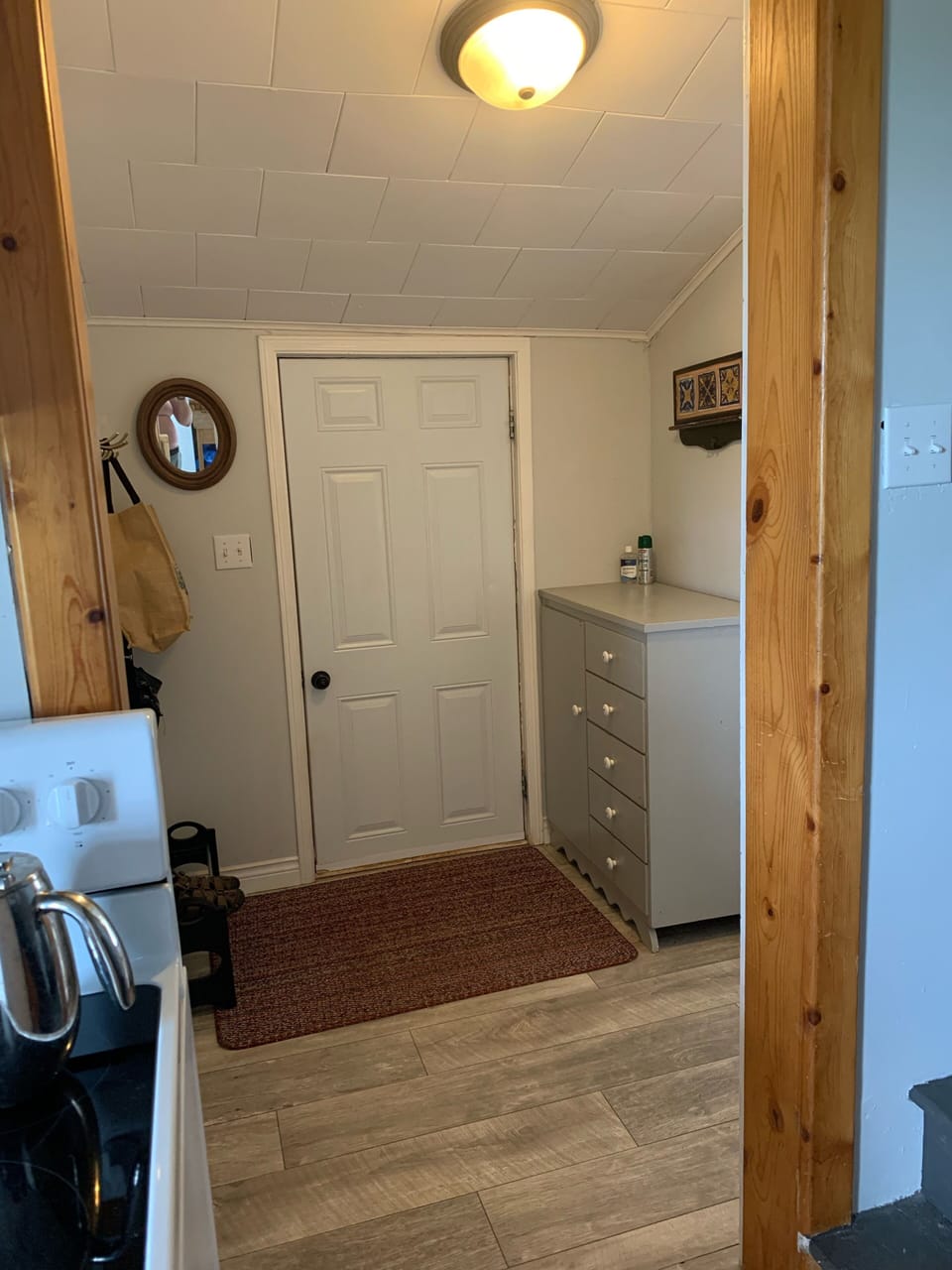 Side entrance and drop zone next to laundry closet. 