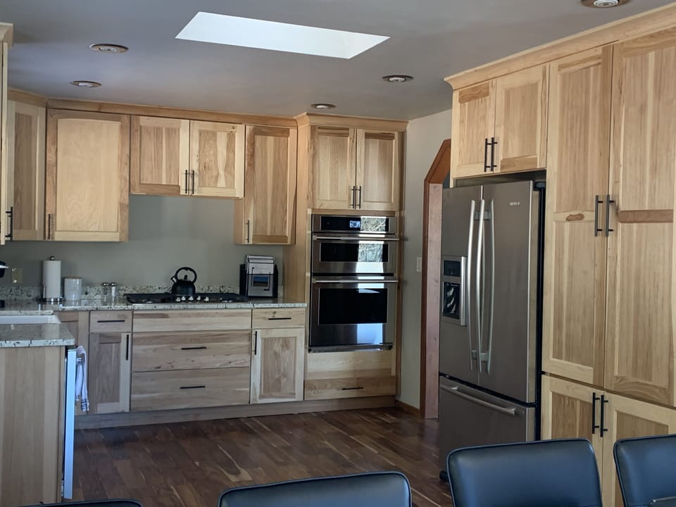 Kitchen has new stainless appliances, farm sink, granite, and gas stovetop.
