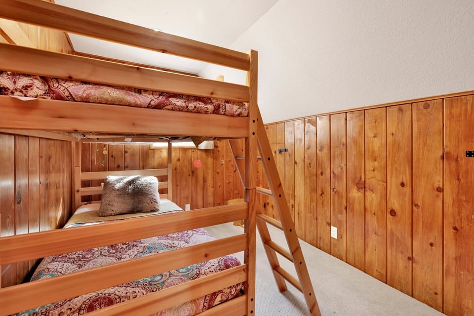 Cozy guest bedroom with bunk beds, warm décor, and inviting layout, perfect for families or groups