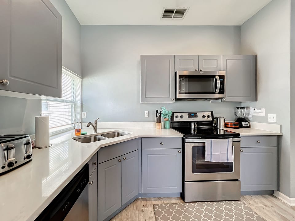 Fully stock kitchens with stainless steel appliances.