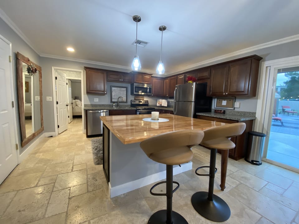 Open floor plan , cottage kitchen living to pool view. 