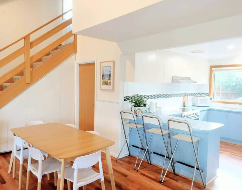 The kitchen is fully equipped with modern conveniences, overlooking the dining area