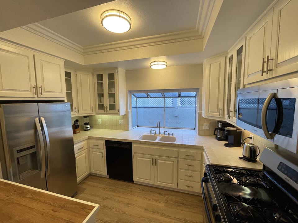Kitchen with gas range, dishwasher, over the range microwave