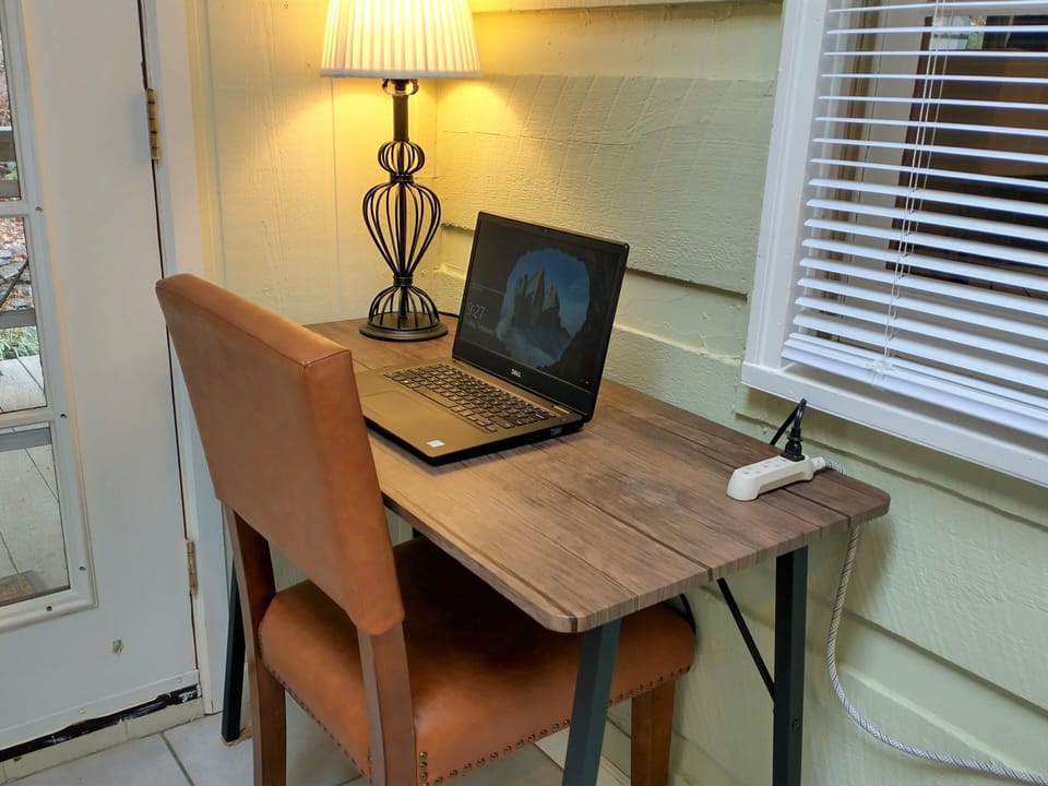 The sun room includes a desk for a dedicated working and schooling space.
