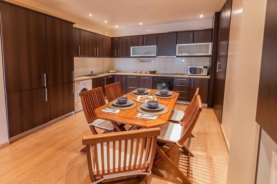 Fully Equipped Kitchen with Dining Area
Includes modern appliances, ample countertop space, and a spacious dining table for shared meals.