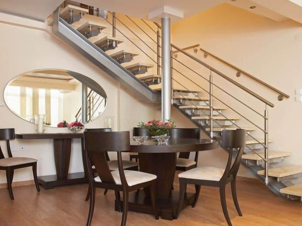 Dining Area with Staircase View
Functional and elegant dining setup adjacent to the main staircase.