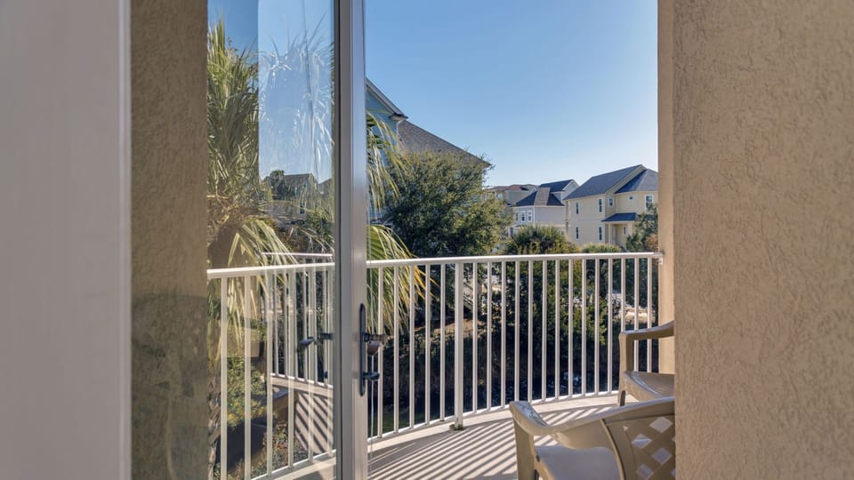 This private balcony offers a peaceful outdoor retreat with treetop and neighborhood views.