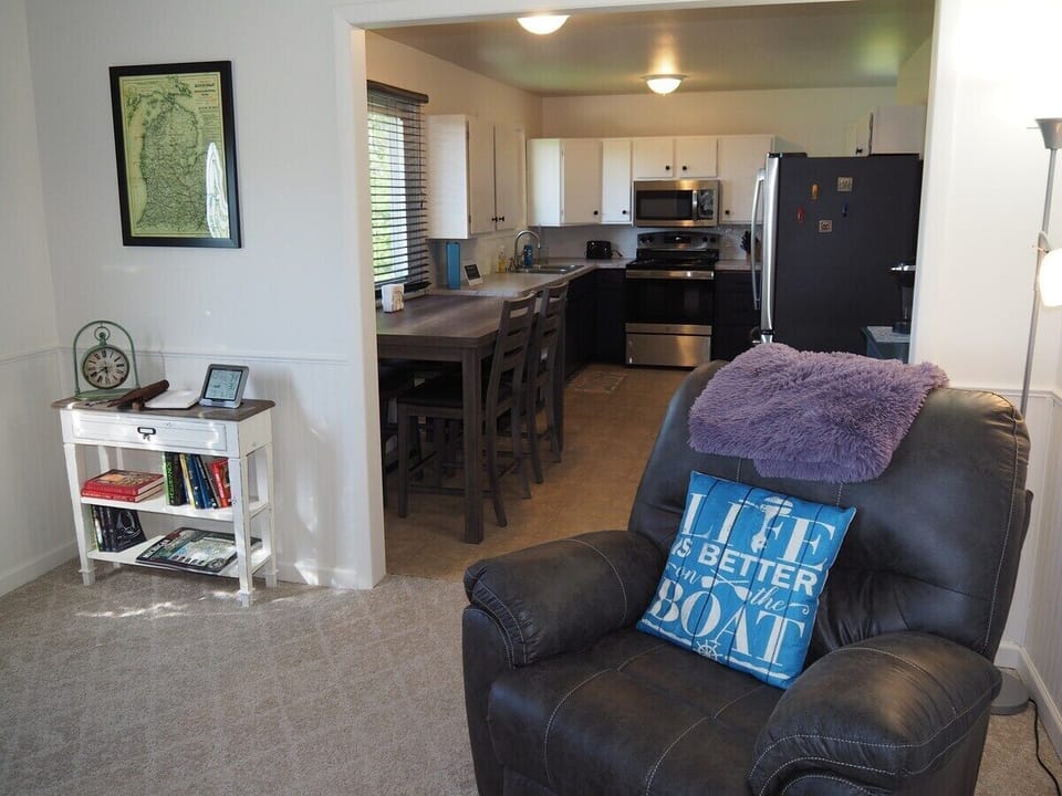LIVING ROOM:  The home has a comfy living room with new furniture and a nice view of Manistee Lake.