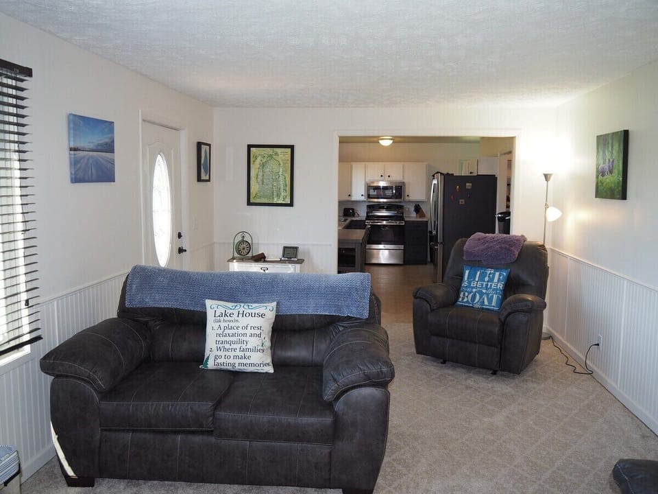 LIVING ROOM:  The home has a comfy living room with new furniture and a nice view of Manistee Lake.