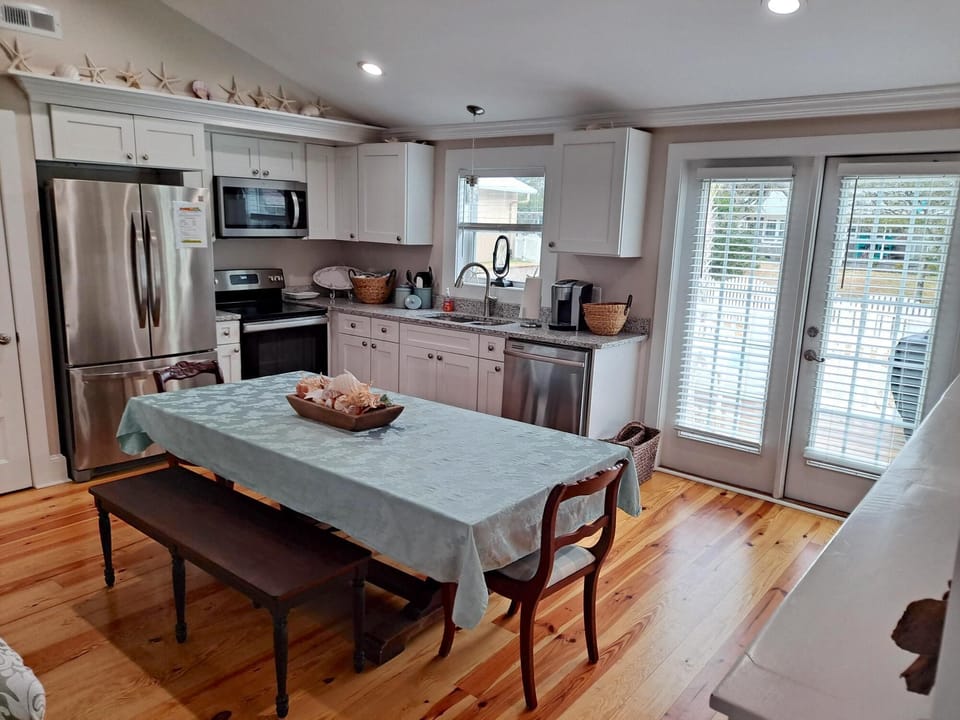Large wooden kitchen table and pine floors
