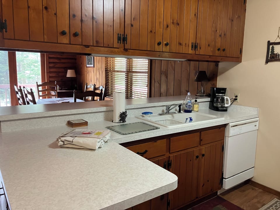 Kitchen & Dining room view. Dishwasher.  Cleaning supplies included.