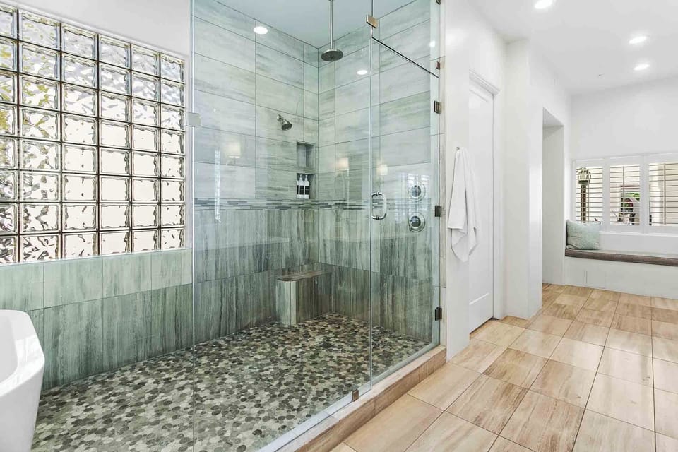 Bedroom 1 - Primary en suite bathroom with double vanities, tub, walk-in shower