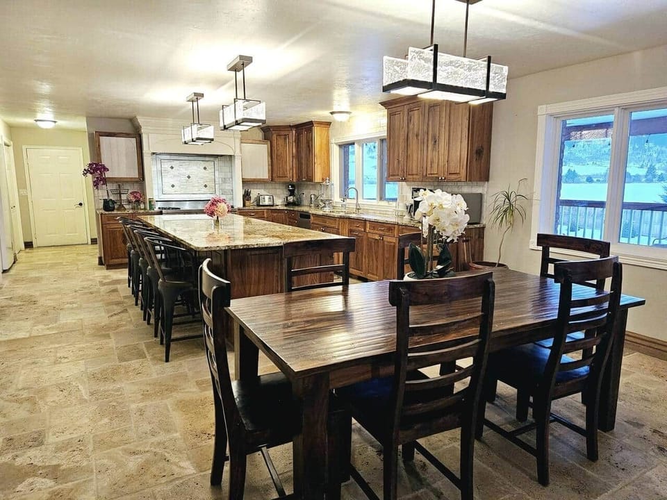 Spacious kitchen with a huge island for buffets, serving, and eating.  A stand-alone fridge and stand-alone freezer provide plenty of room for large gatherings.  Well-stocked kitchen with 48-inch Viking double oven, Kitchen aid mixer & bread machine