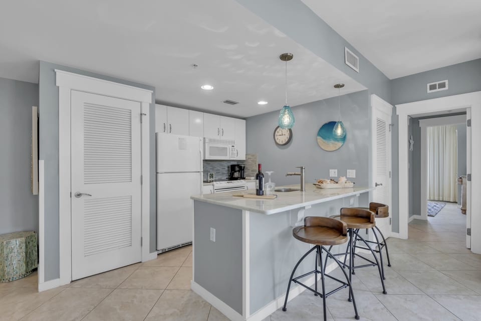 quartz countertops create a luxe, pristine workspace that’s fully equipped 