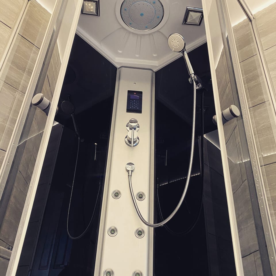 Pod shower ,with built in radio ,body massage jets,and rainfall shower 