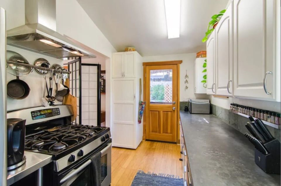 Kitchen door to back yard affords climatic flow to enjoy your meals al fresco.