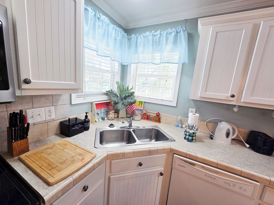 Full kitchen with glass top stove and oven, dishwasher and more.