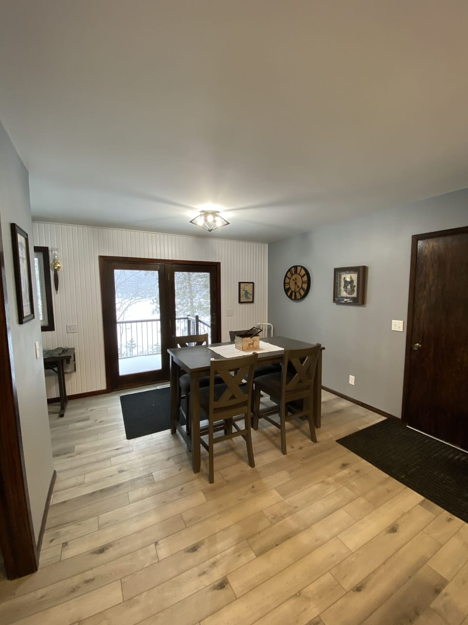 Dining area overlooks the deck and waterfront through patio doors.