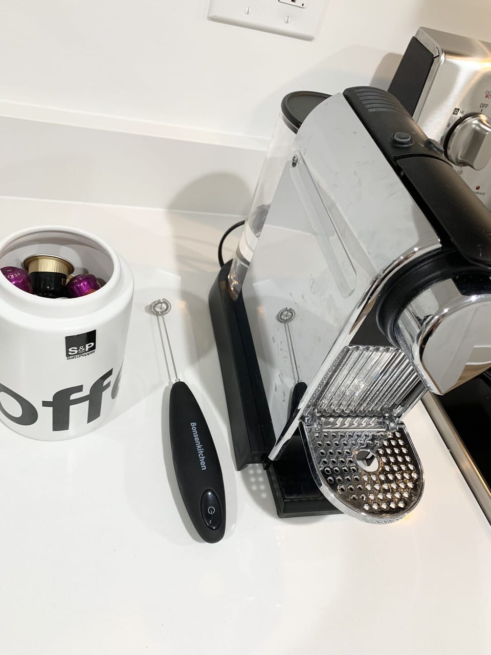 Nespresso machine, milk frother, and variety of nespresso pods provided