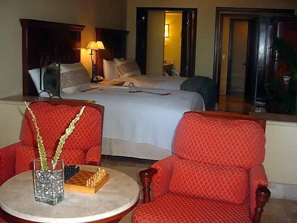 Queen bedroom with sitting area as viewed from the porch looking toward bathroom