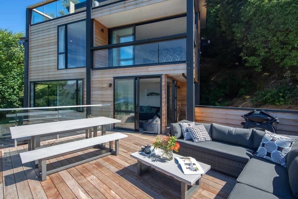 Spacious Deck with Lakefront and Mountain Views – Relax on this generous deck, complete with a BBQ and cozy seating, offering tranquil views of the lake and mountains, perfect for outdoor relaxation and dining.